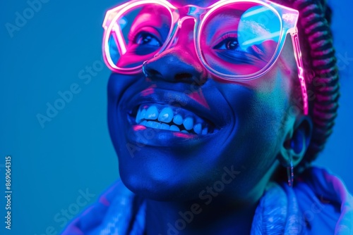 Wallpaper Mural Portrait of young smiling student on dark blue background in neon light Torontodigital.ca