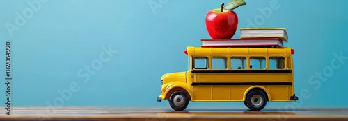 A toy School bus with books and an apple on top,  back to school concept.