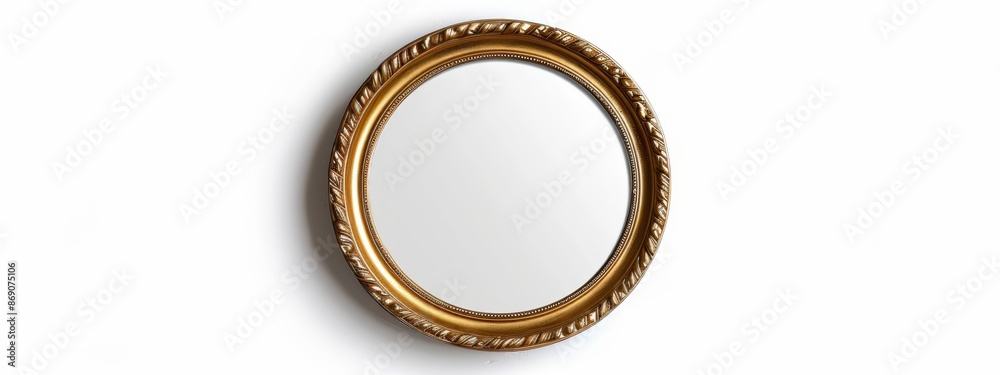 A golden oval mirror rests atop a pristine white wall, adjacent to a wall-mounted toilet paper dispenser A golden oval mirror rests atop a pristine white wall, adjacent to a wall-mounted toilet paper dispenser