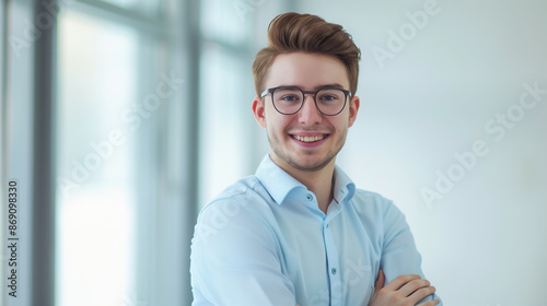 Young confident man wearing glasses in the office looking confident and smiling