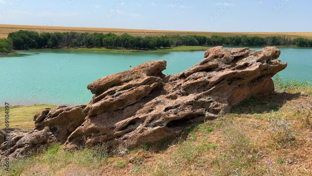 Rock formation with wind cracks on the lake shore Rock formation with wind cracks on the lake shore