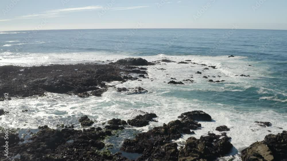 4K drone flight over rocky California coast at Monterey Bay with tide pools and seagulls visible below. 4K drone flight over rocky California coast at Monterey Bay with tide pools and seagulls visible below.