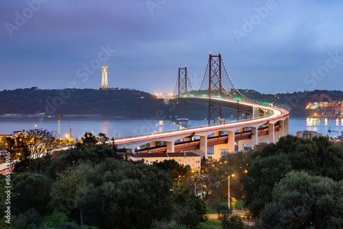 25th April bridge and the Christ the King (Cristo Rei) sanctuary taken at dusk over the Tagus estuary, Lisbon, Portugal