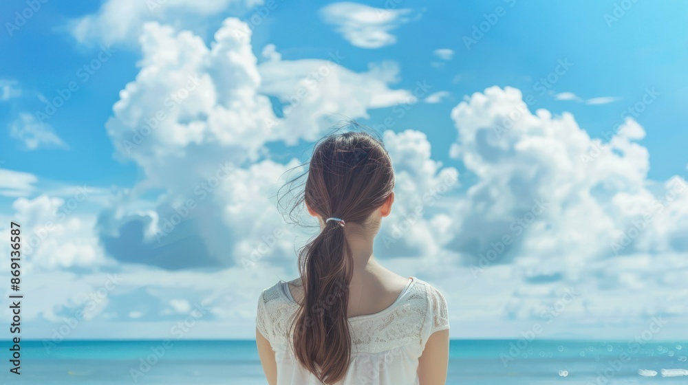 Woman with ponytail gazing at a serene blue sky and ocean horizon, capturing tranquility and vastness of the seascape. Woman with ponytail gazing at a serene blue sky and ocean horizon, capturing tranquility and vastness of the seascape.