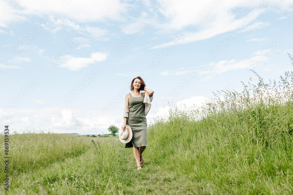 Happy woman walking on grass in field Happy woman walking on grass in field