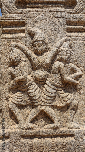 Ancient sculpture of three men on a pillar, Veerabhadra Swamy Temple Mandapa, Lepakshi, Andhra Pradesh, India photo