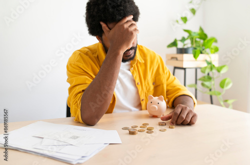 Young man worried about saving money and paying bills