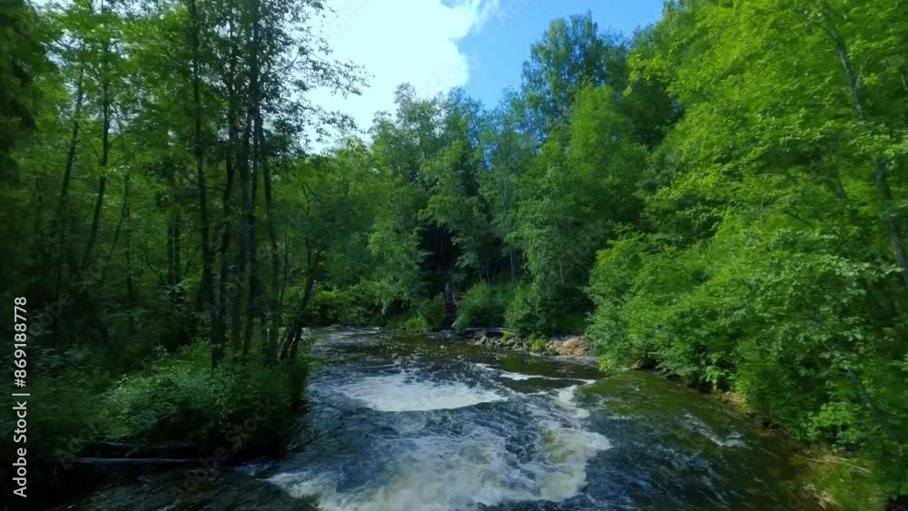 Smooth, rapid FPV flight over a mountain river close to the water, among a dense russian forest. Mystical landscape, forest waterfall. Smooth, rapid FPV flight over a mountain river close to the water, among a dense russian forest. Mystical landscape, forest waterfall.