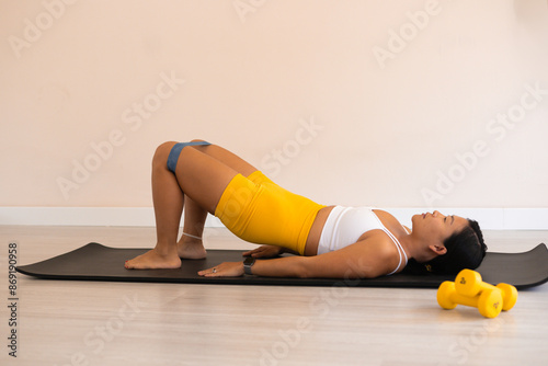 Woman with a sporty body exersising in a fitness studio photo