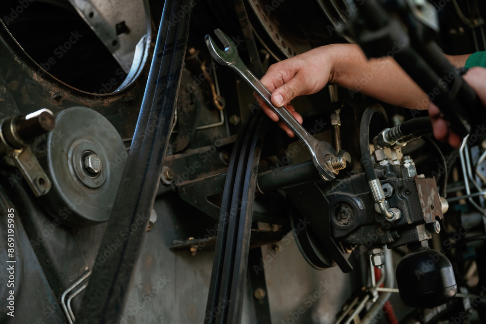 Fototapeta premium Mechanic working on industrial machinery in a workshop