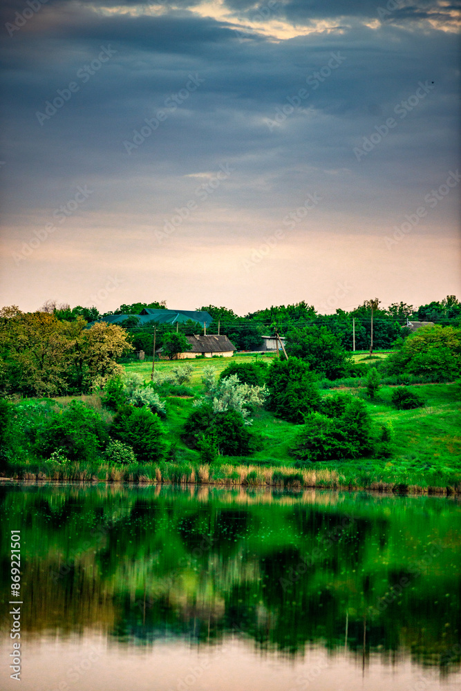 Sunset over the river . Another river beach. May and trees . Green colors . Reflections on water . Fising on river . Golden sunset Sunset over the river . Another river beach. May and trees . Green colors . Reflections on water . Fising on river . Golden sunset