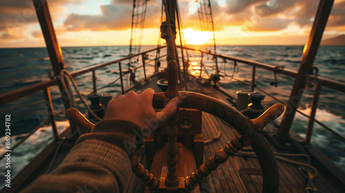 captain hand holding the steering wheel of an old wooden sailboat, with waves gently lapping against its side and the setting sun in the background, symbolizing adventure on sea photo