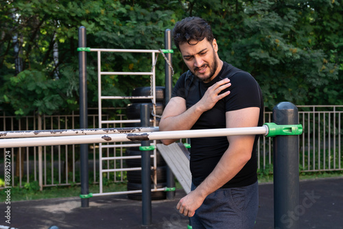 An athlete suffering from severe shoulder pain injured his joint while training on the parallel bars