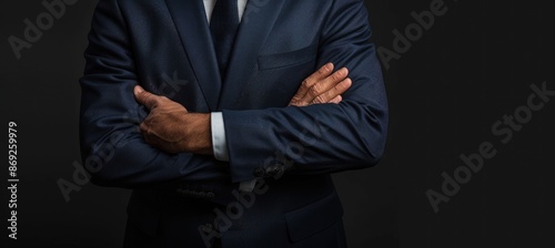 Confident Man in a Suit with Crossed Arms