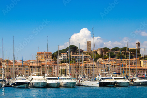Obraz na płótnie Luxury yachts, modern buildings, and sailboats in a beautiful Mediterranean marina view. Old city and harbor in Cannes, French Riviera, France. w salonie