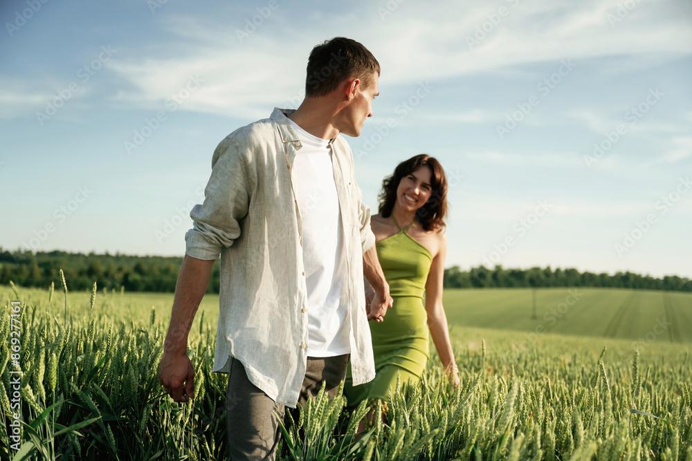 Having fun. Lovely couple are on the agricultural field together Having fun. Lovely couple are on the agricultural field together
