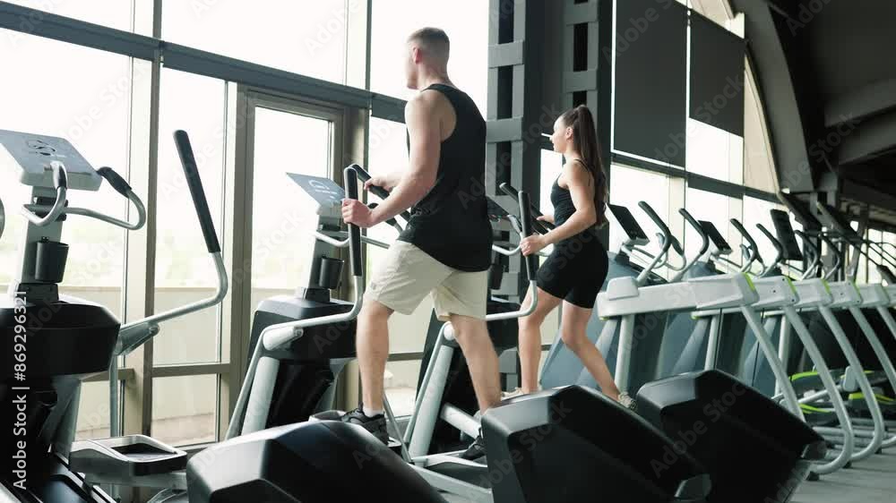 Active American and Hispanic Couple Engaging in Gym Workout Promoting Active Lifestyles Active American and Hispanic Couple Engaging in Gym Workout Promoting Active Lifestyles