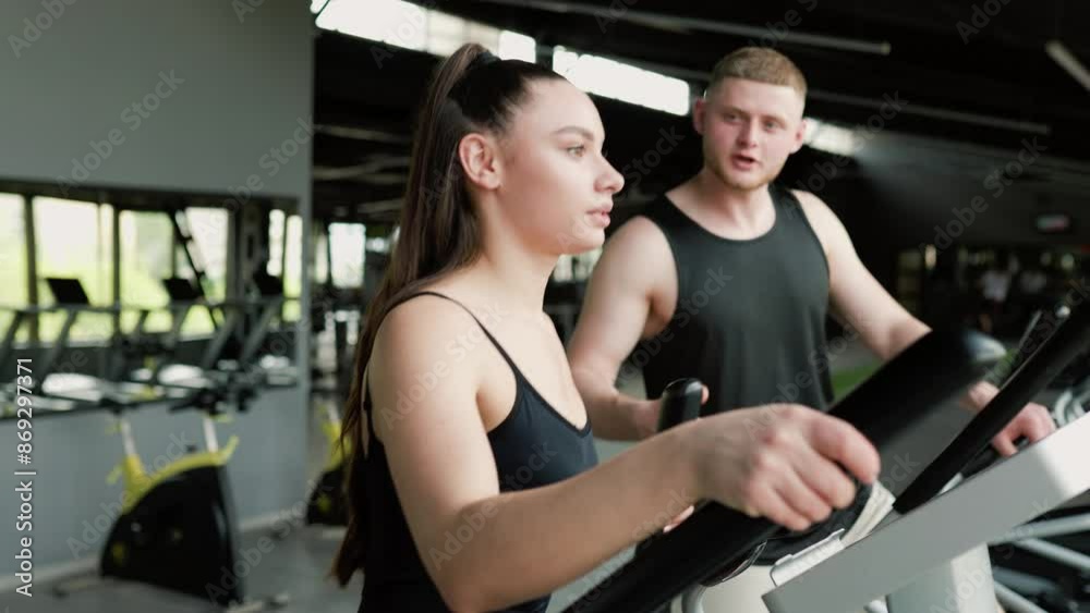 Dynamic Duo Young Woman Gets Motivated by Male Personal Trainer in Gym Dynamic Duo Young Woman Gets Motivated by Male Personal Trainer in Gym