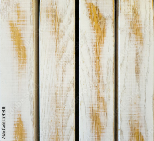 A row of yellowish wood planks painted white and peeling, rubbed, faded, Surface for commercial photography, vintage products, wrapping 3D models. Free space for text. Top shot, close up, micro