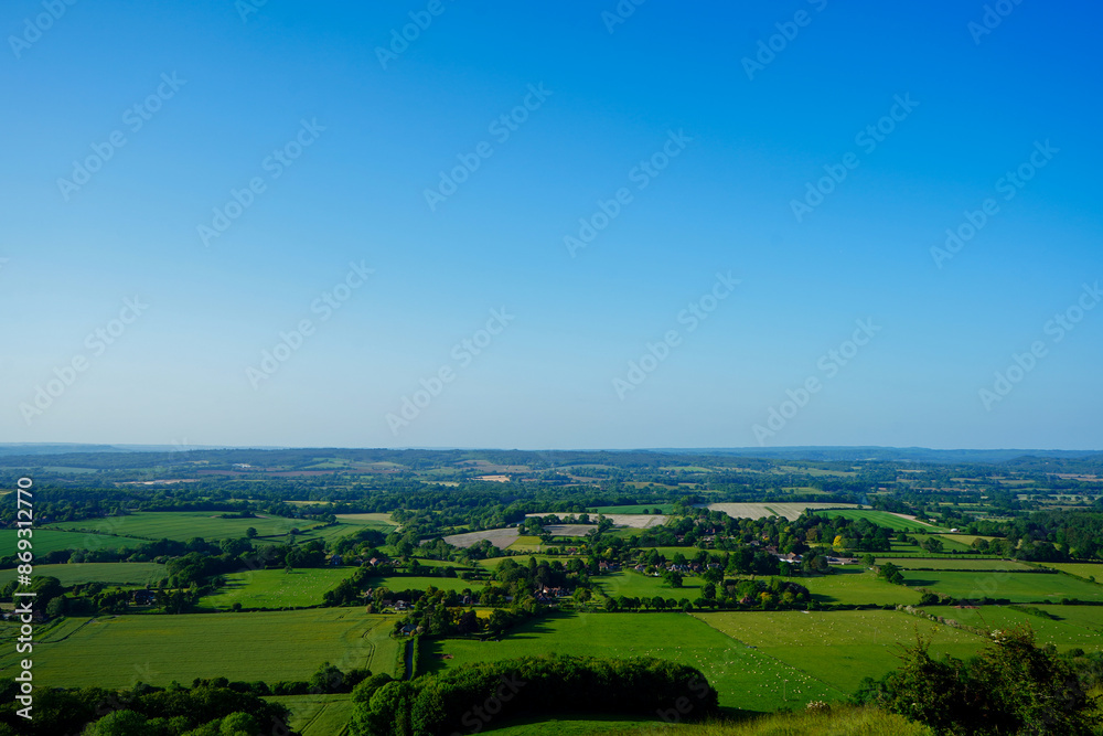 View of green farm fields and blue sky in the South of England View of green farm fields and blue sky in the South of England
