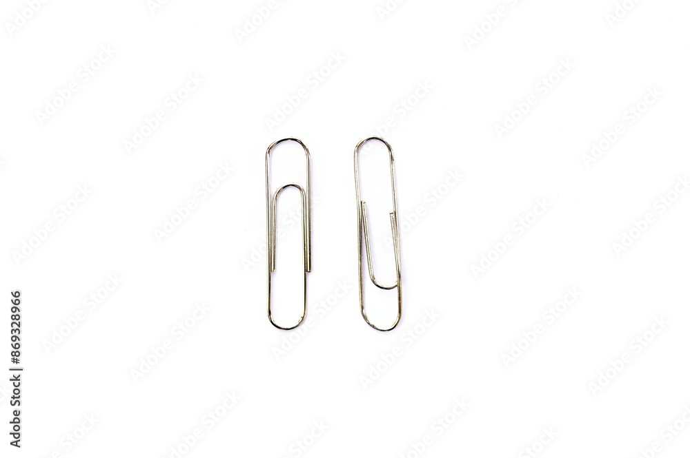 Metal clip. Minimalism office paper clip for important documents and files. White background, isolation. Metal clip. Minimalism office paper clip for important documents and files. White background, isolation.
