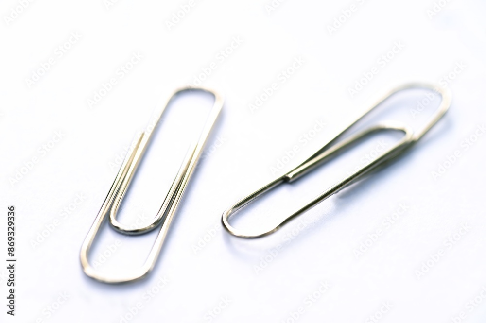 Metal clip. Minimalism office paper clip for important documents and files. White background, isolation. Metal clip. Minimalism office paper clip for important documents and files. White background, isolation.