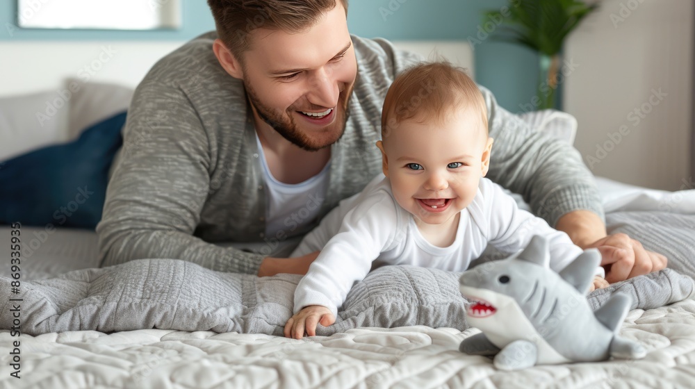 Obraz premium A smiling baby plays with stuffed animals on a couch while a grandfather watches with a smile