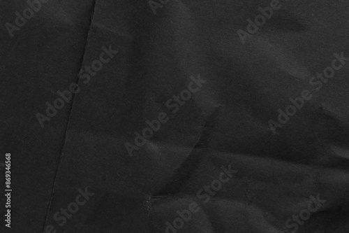 Classic abstract background from crumpled folded black paper and rough dusty textured surface