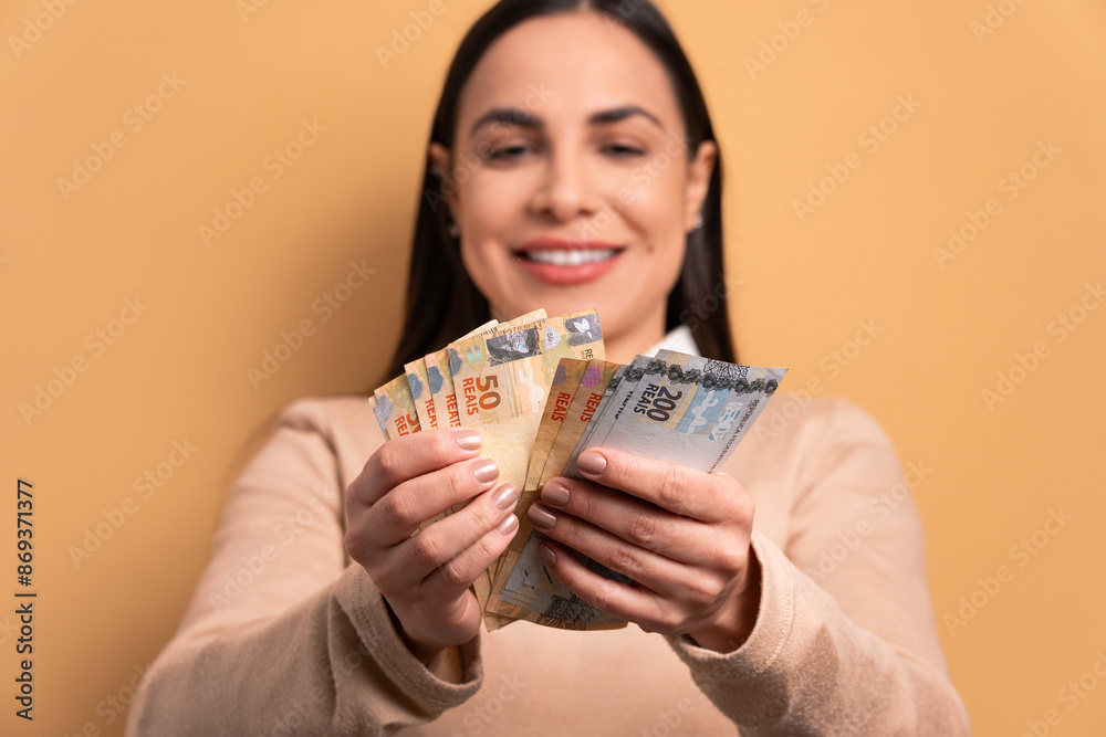 happy young woman with brazil banknotes currency in all beige colors. economy, payment, successful concept. happy young woman with brazil banknotes currency in all beige colors. economy, payment, successful concept.