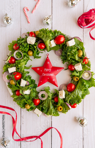 Close-up of the Christmas wreath salad with vegetables and feta cheese on the dark background. Selective focus