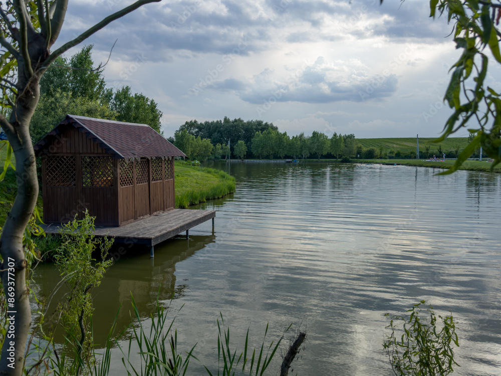 Obraz premium Discover the perfect fishing spot on our serene lake. Enjoy tranquil surroundings, clear waters, and the thrill of the catch. Ideal for a relaxing day in nature with friends and family.