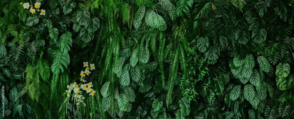 ush green plant with a few yellow flowers in the foreground ush green plant with a few yellow flowers in the foreground