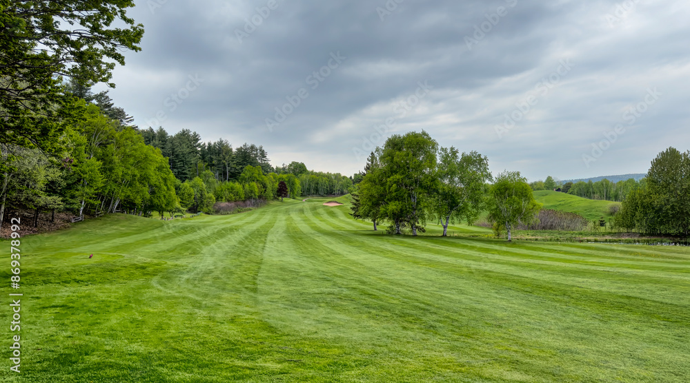 A green golf course and blue cloudy sky on a beautiful summer day in Canada A green golf course and blue cloudy sky on a beautiful summer day in Canada