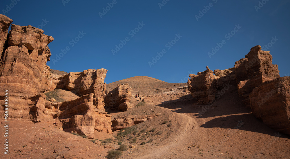 majestic red sandstone cliffs against a vibrant blue sky, suggesting a serene summer day in a desert landscape, midday considering the bright sunlight majestic red sandstone cliffs against a vibrant blue sky, suggesting a serene summer day in a desert landscape, midday considering the bright sunlight