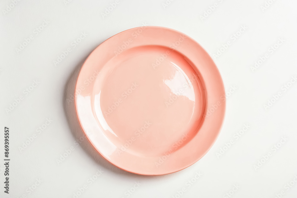 Empty pink plate on a white background Empty pink plate on a white background