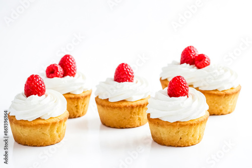 Delicious Cupcakes with Whipped Cream and Raspberries