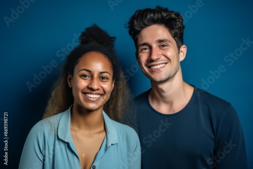 Smiling portrait of a young interracial couple on colorful background © Vorda Berge