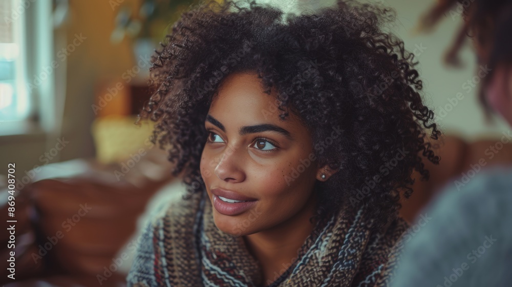 A young woman with beautiful curly hair smiles warmly indoors, highlighting her natural beauty and friendly demeanor. A young woman with beautiful curly hair smiles warmly indoors, highlighting her natural beauty and friendly demeanor.