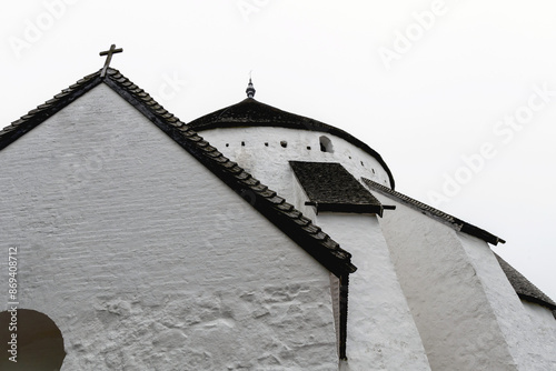 White round Osterlars church on the island of Bornholm. Concept of historical building and landmarks of Denmark.  photo