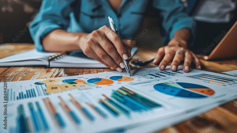 Businesspeople analyzing financial data and working on a strategy report for success Businesspeople analyzing financial data and working on a strategy report for success