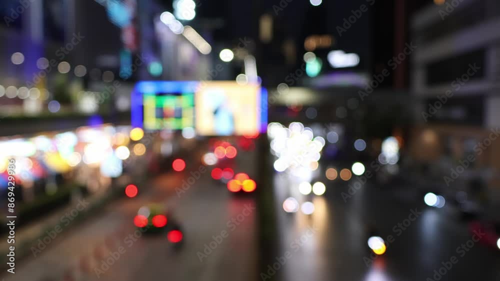 Road traffic near MBK Center in Bangkok, Thailand.  Bokeh of cars and blurred traffic lights.