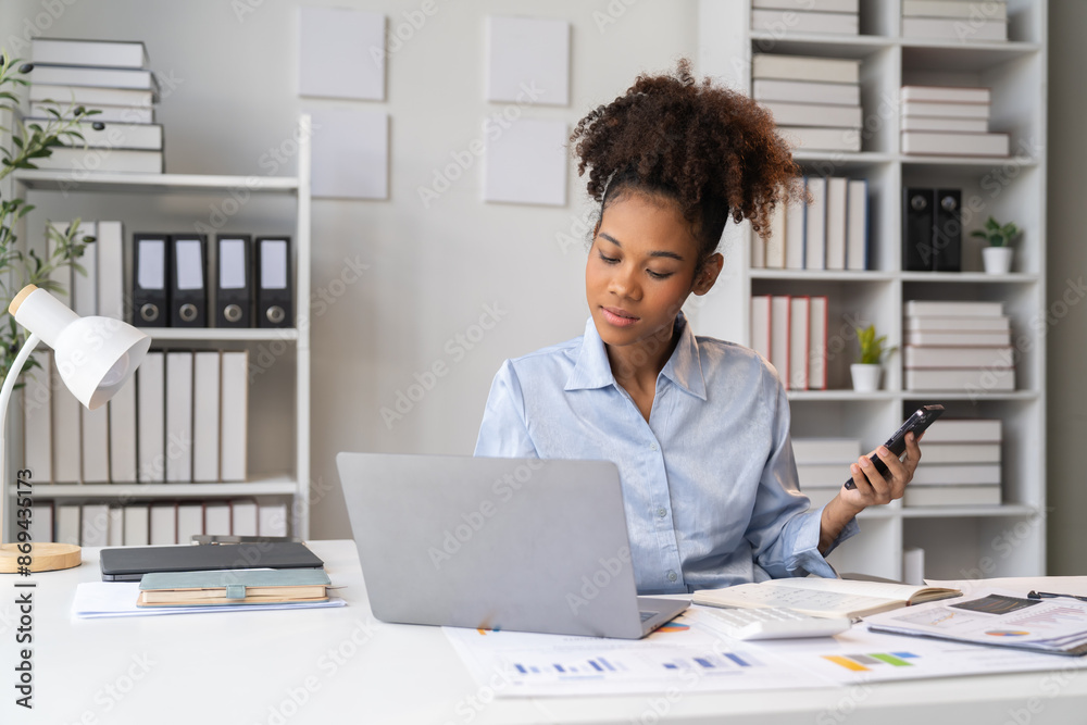 Female Entrepreneur. Cheerful African American Businesswoman Working On document and Laptop In Modern Office. Empty Space Female Entrepreneur. Cheerful African American Businesswoman Working On document and Laptop In Modern Office. Empty Space
