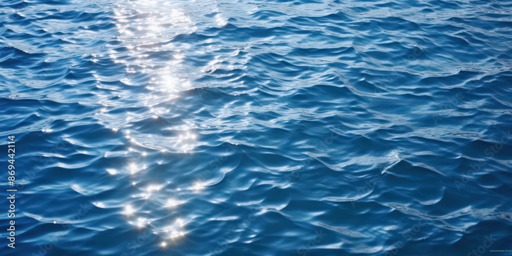 Fototapeta premium Sun Glints on Rippling Blue Water, sparkling sunlight reflecting on the deep blue sea
