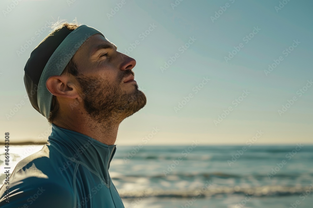 Serious runner breathing deeply fresh air on the beach after sport Serious runner breathing deeply fresh air on the beach after sport
