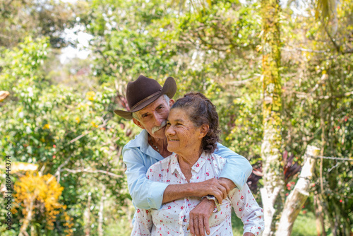 Lifestyle: Elderly husband and wife. husband embraces wife