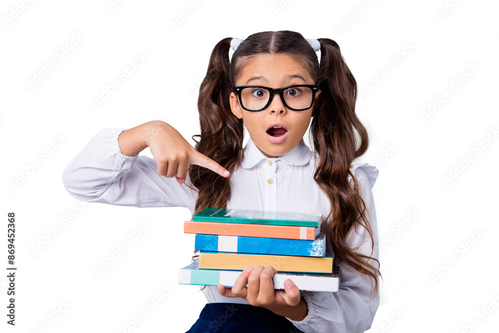 Funny cute cheerful lovely stylish adorable small little clever girl with curly pigtails in white formal blouse shirt and blue skirt, holding, pointing at book pile. Isolated over grey background Funny cute cheerful lovely stylish adorable small little clever girl with curly pigtails in white formal blouse shirt and blue skirt, holding, pointing at book pile. Isolated over grey background