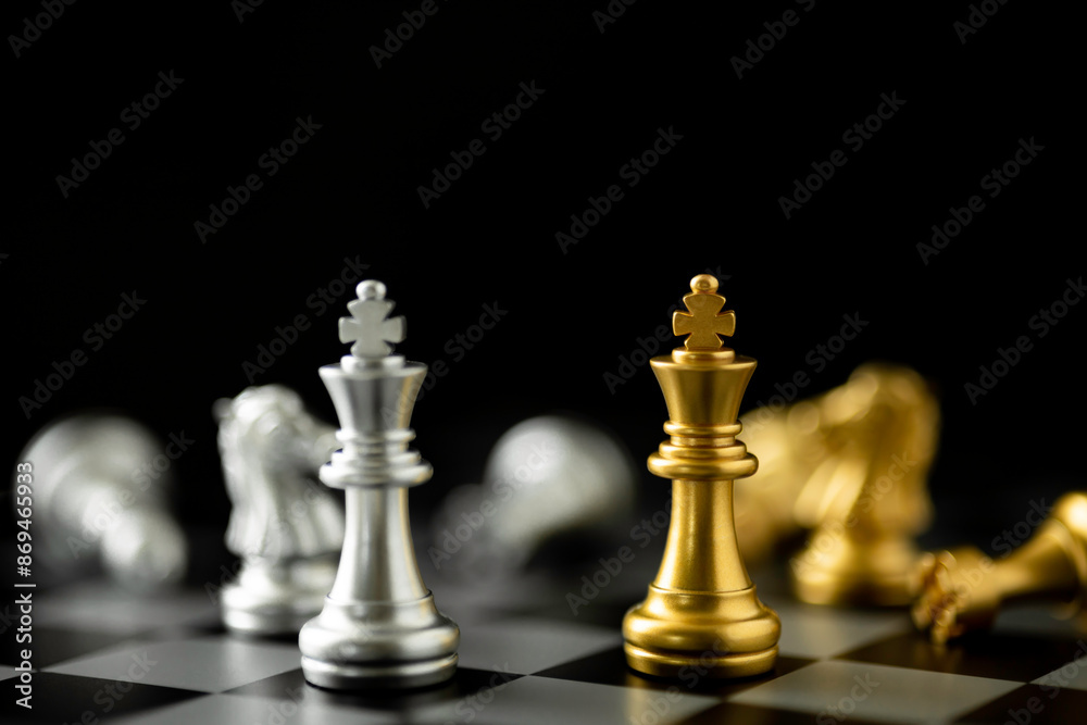 Golden and Silver King chess standing in front of other chess on chess board. Golden and Silver King chess standing in front of other chess on chess board.