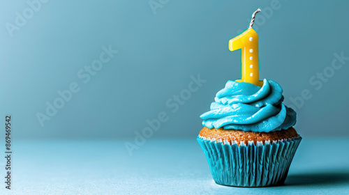 A blue cupcake with a number one candle on it sits on a blue background.
