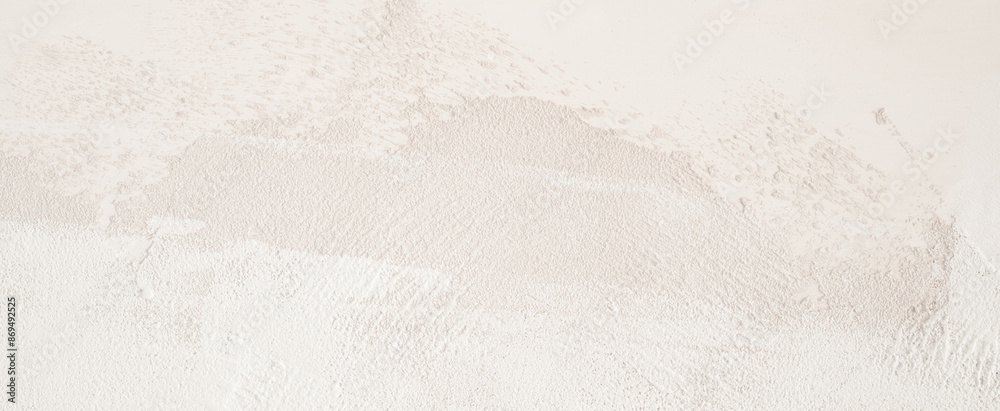 Obraz premium White wall background. A close-up shot of a white textured wall surface, showing a slightly grainy and uneven pattern.