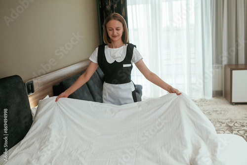 Busy, conception of work and occupation. Young chambermaid is in hotel room
